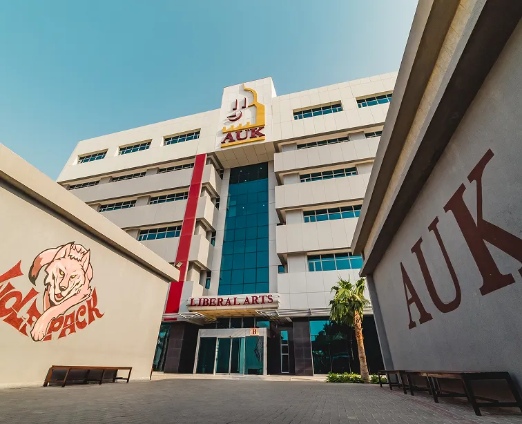 The artistic AUK WolfPack design and AUK logo creatively displayed on the wall in front of the Liberal Arts building.