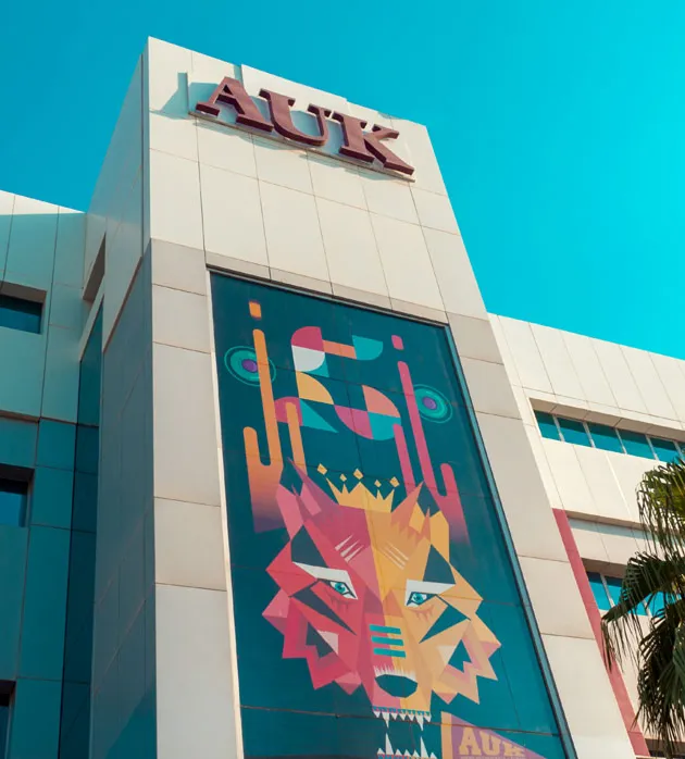 A striking daytime view of the AUK campus building, showcasing its architectural beauty