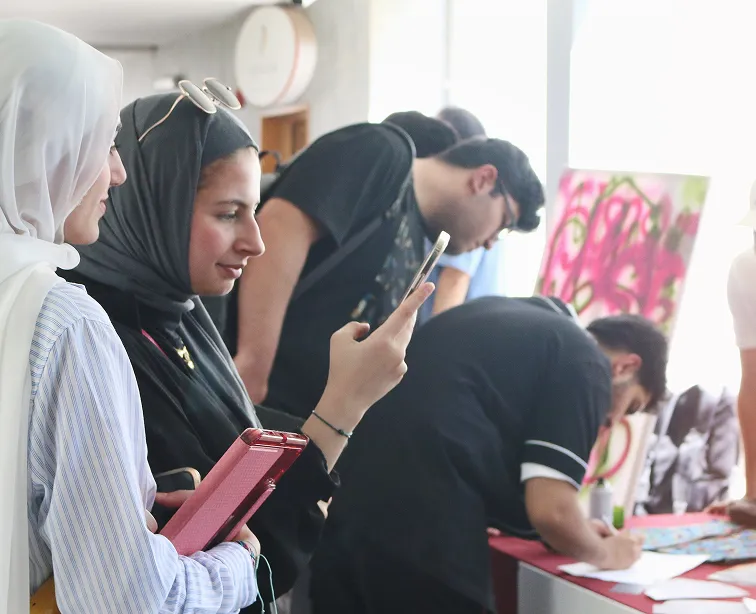 AUK students registering and preparing their entries for an upcoming exhibition, contributing creative works