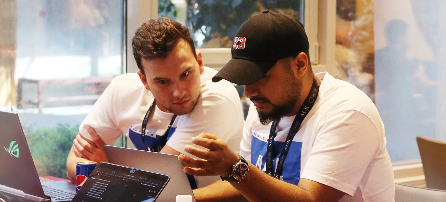 Two AUK faculty members deeply engrossed in a meaningful conversation, fostering intellectual exchange.