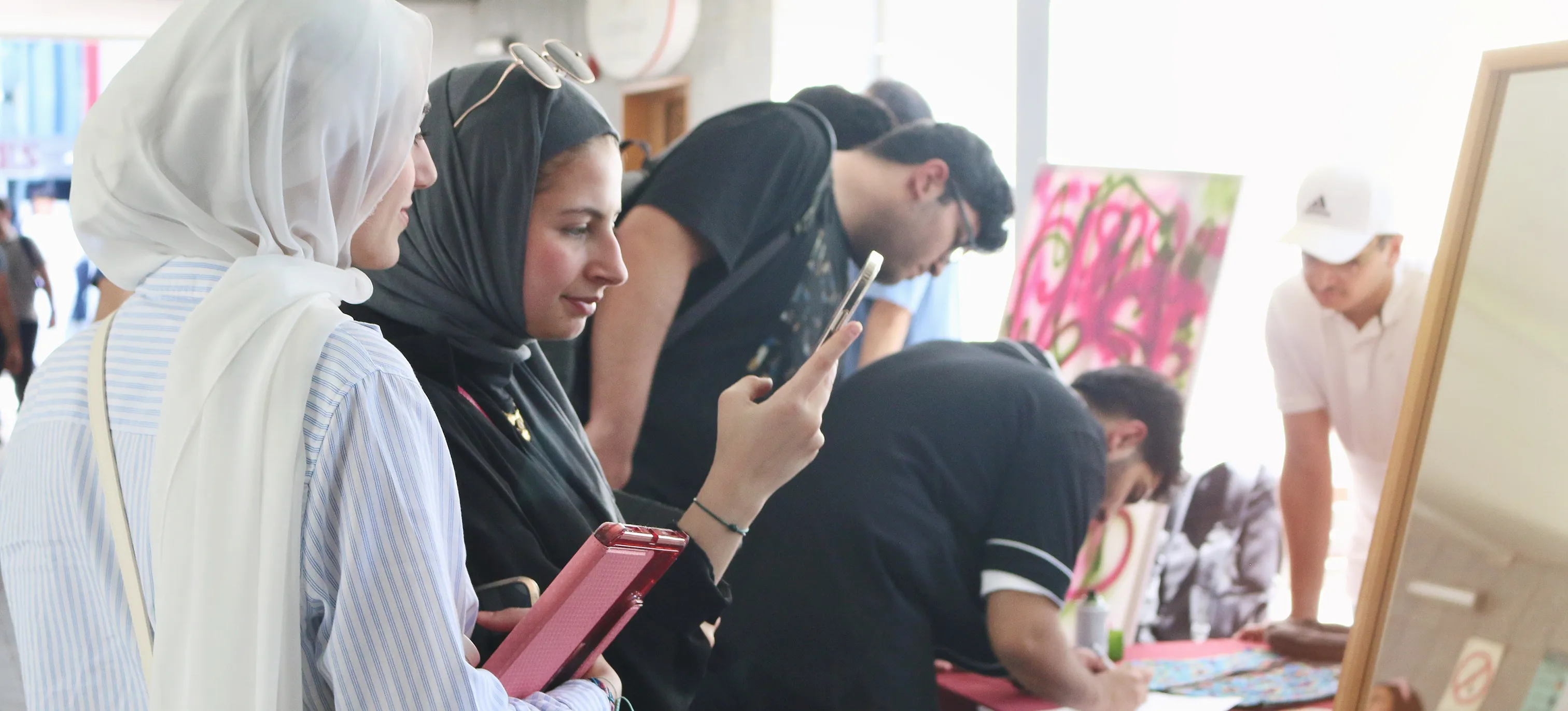 AUK students registering and preparing their entries for an upcoming exhibition, contributing creative works